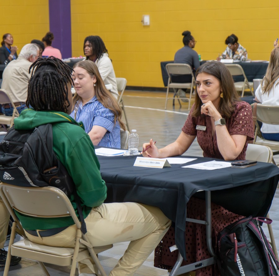 Students practicing mock interviews with local professionals